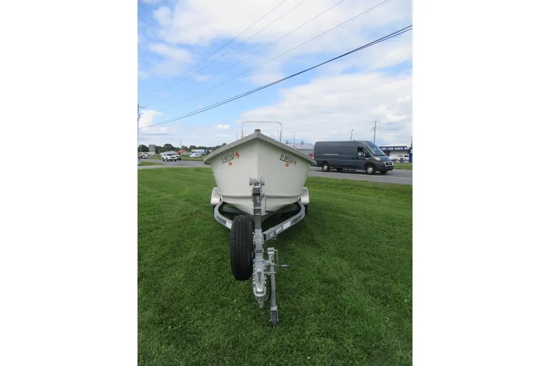 Slide: The Image of 2015 Allied 17 Sportsman boat on trailer, parked on grass under a cloudy sky. - 2