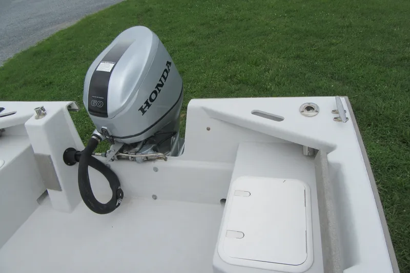 Slide: The Image of 2015 Allied 17 Sportsman boat with Honda 60 outboard motor, parked on grass. - 19