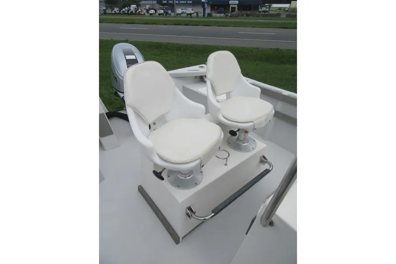 Slide: The Image of Two white swivel seats on a 2015 Allied 17 Sportsman boat deck. - 17