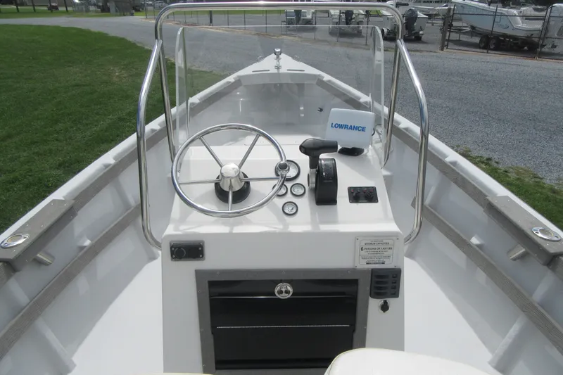 Slide: The Image of 2015 Allied 17 Sportsman boat dashboard with steering wheel and navigation equipment. - 13