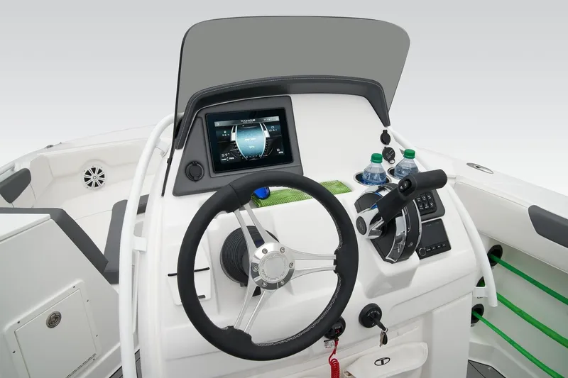 Slide: The Image of 2026 Tahoe 2150 CC boat dashboard with steering wheel, touchscreen display, and throttle controls. - 14