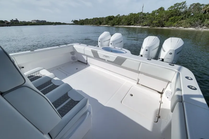 Slide: The Image of 2025 Invincible 35 Catamaran with spacious deck and powerful outboard engines on calm water. - 39