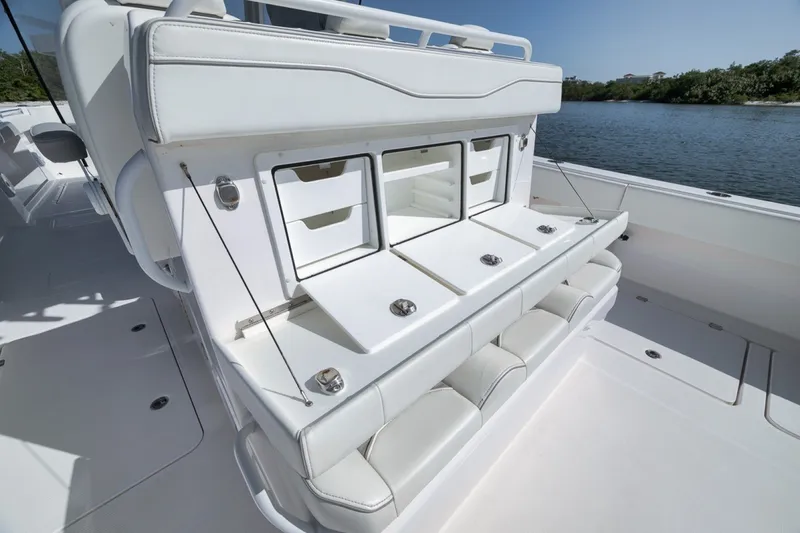 Slide: The Image of 2025 Invincible 35 Catamaran interior with sleek white seating and storage compartments. - 38