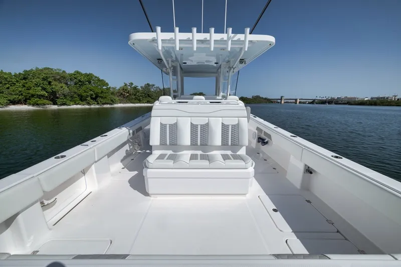 Slide: The Image of 2025 Invincible 35 Catamaran on calm water, showcasing sleek design and spacious deck. - 37