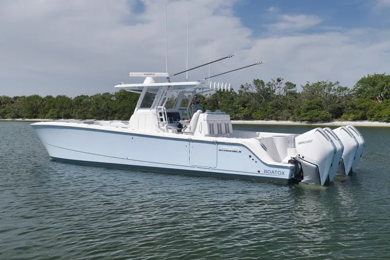 Slide: The Image of 2025 Invincible 35 Catamaran with triple Mercury engines on calm water. - 9