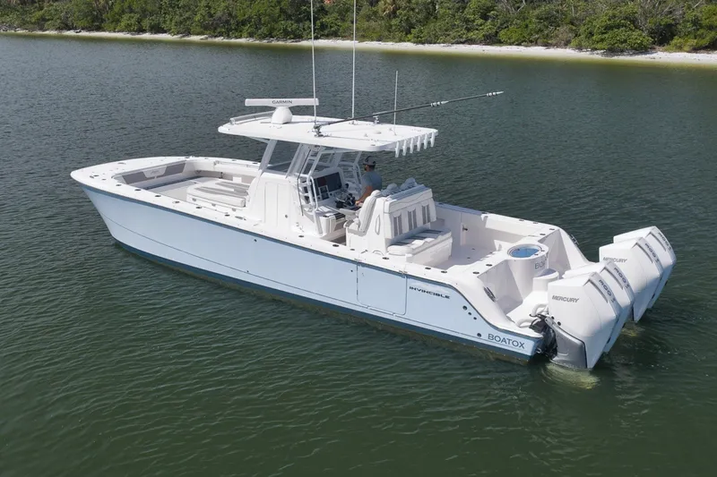 Slide: The Image of 2025 Invincible 35 Catamaran on calm water, featuring twin Mercury engines. - 10