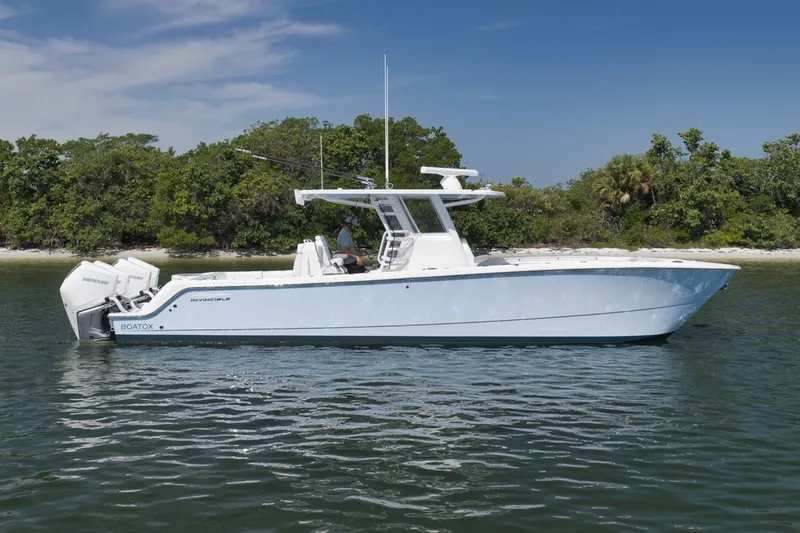 The Image of 2025 Invincible 35 Catamaran on calm water, showcasing sleek design and powerful engines. - 1