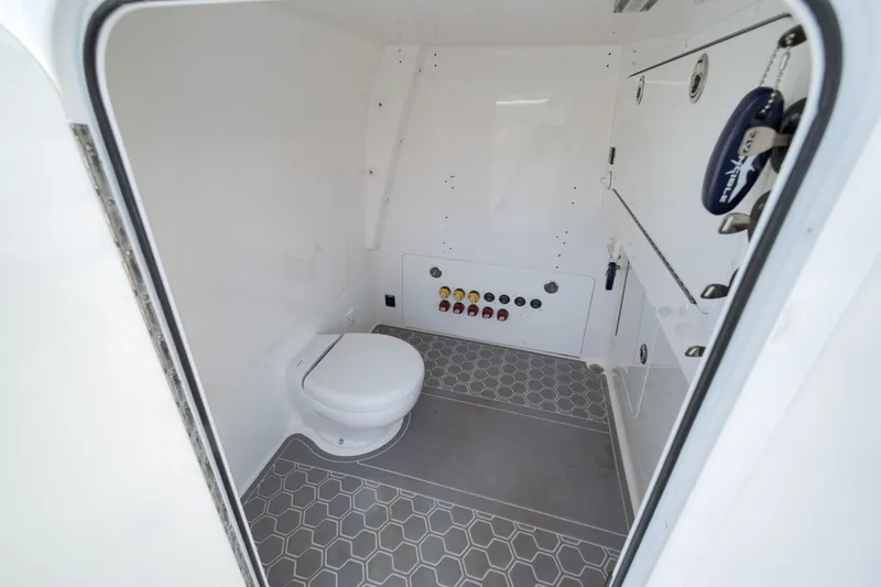 Slide: The Image of Interior of 2025 Invincible 35 Catamaran bathroom with modern fixtures and hexagonal flooring. - 27