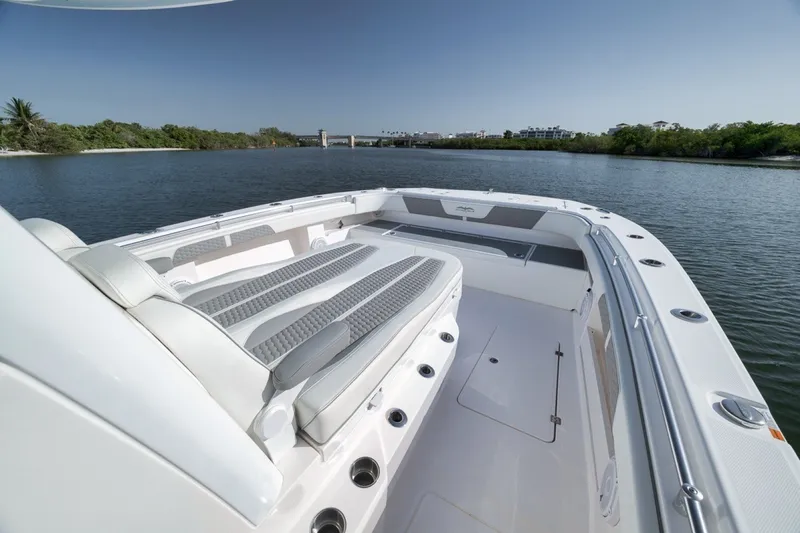 Slide: The Image of 2025 Invincible 35 Catamaran on calm water, showcasing spacious deck and seating. - 21
