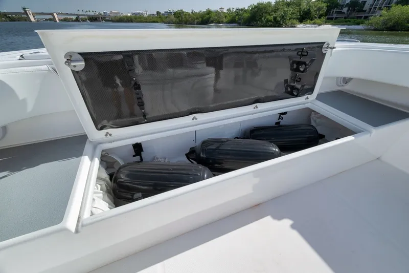 Slide: The Image of Open storage compartment on 2025 Invincible 35 Catamaran, showcasing interior space and equipment. - 19