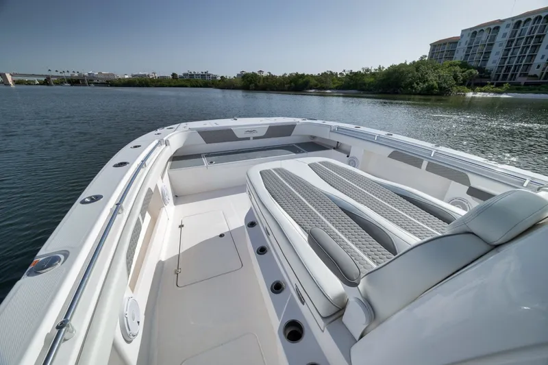 Slide: The Image of 2025 Invincible 35 Catamaran with luxurious seating on calm waters. - 26