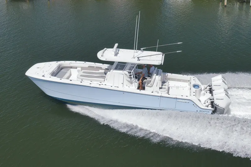 Slide: The Image of 2025 Invincible 35 Catamaran cruising on water, showcasing sleek design and powerful engines. - 47