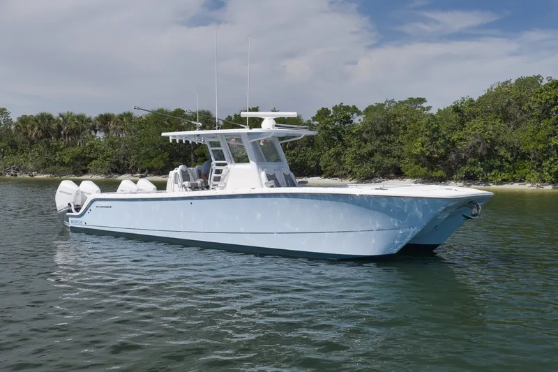 Slide: The Image of 2025 Invincible 35 Catamaran on water, sleek design, lush greenery background. - 2