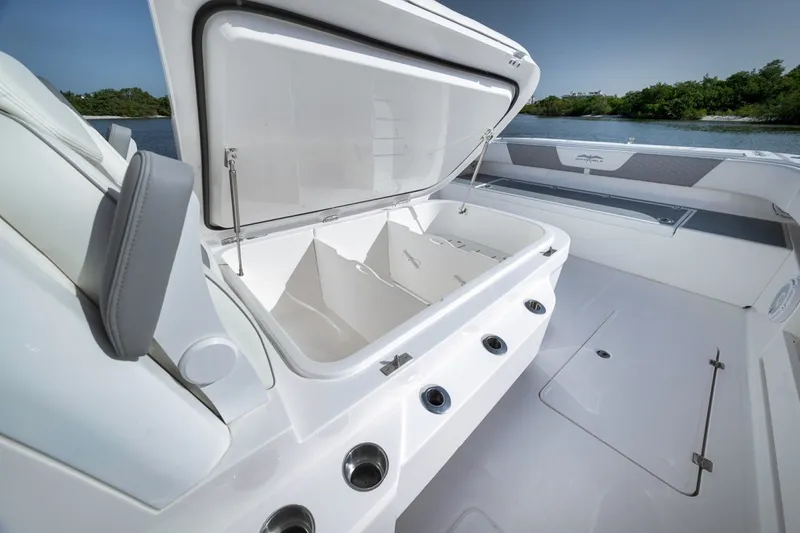 Slide: The Image of 2025 Invincible 35 Catamaran with open storage compartment, sleek design, and spacious deck. - 24