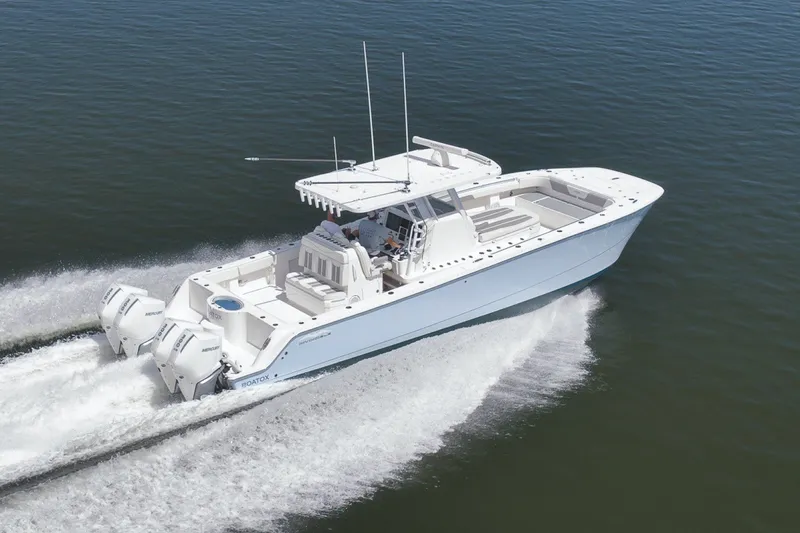 Slide: The Image of 2025 Invincible 35 Catamaran cruising on open water, showcasing sleek design and powerful engines. - 49
