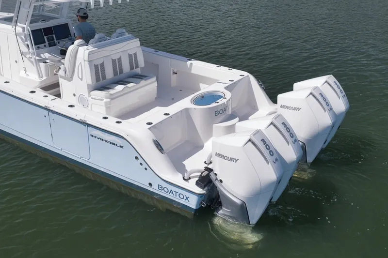 Slide: The Image of 2025 Invincible 35 Catamaran with quad Mercury engines on calm water. - 11