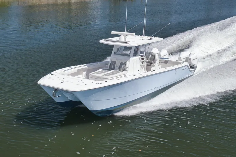 Slide: The Image of 2025 Invincible 35 Catamaran cruising on water, showcasing sleek design and powerful performance. - 13