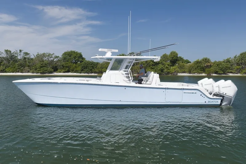 Slide: The Image of 2025 Invincible 35 Catamaran on calm water, featuring sleek design and powerful engines. - 8