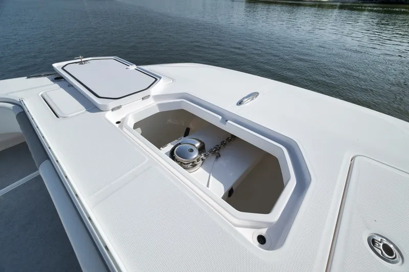 Slide: The Image of 2025 Invincible 35 Catamaran anchor compartment on calm water. - 16