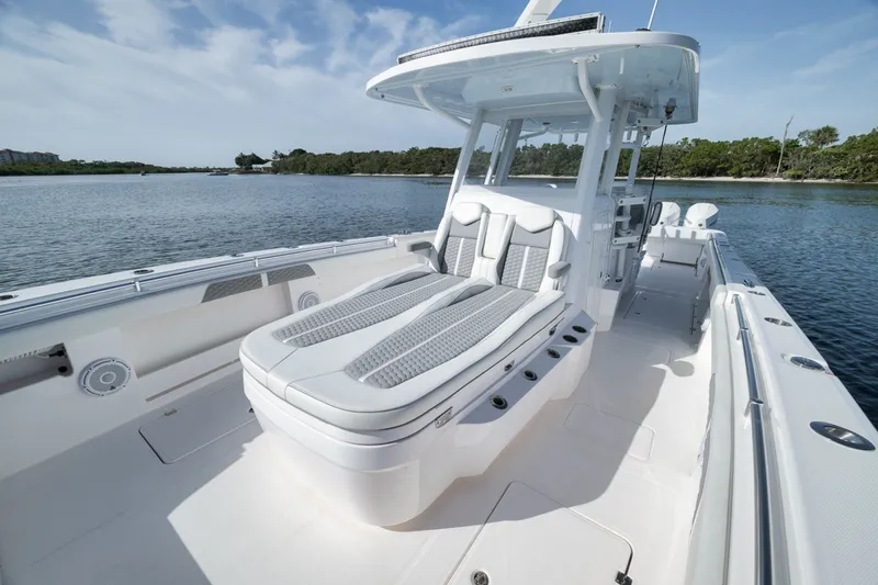 Slide: The Image of 2025 Invincible 35 Catamaran with sleek seating, cruising on a serene waterway. - 25