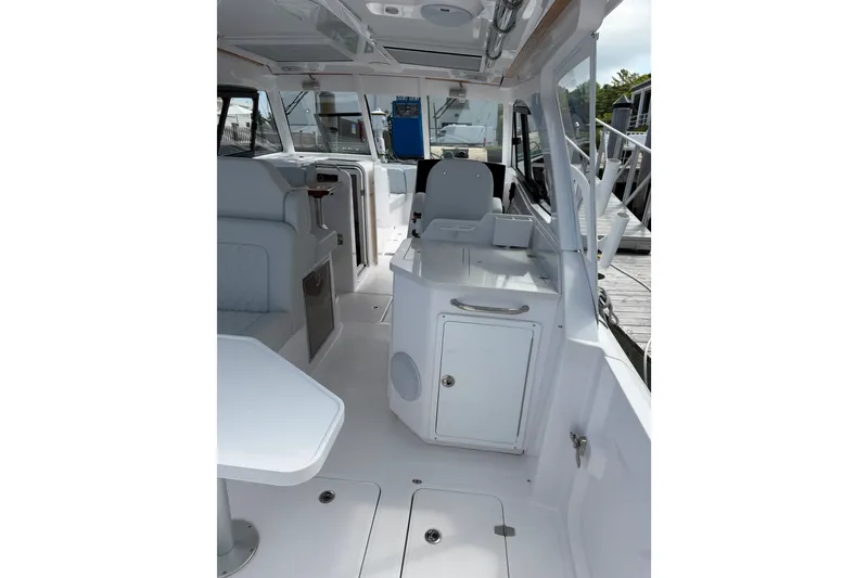 Slide: The Image of 2024 Southport 33 DC boat interior with seating and storage compartments. - 16