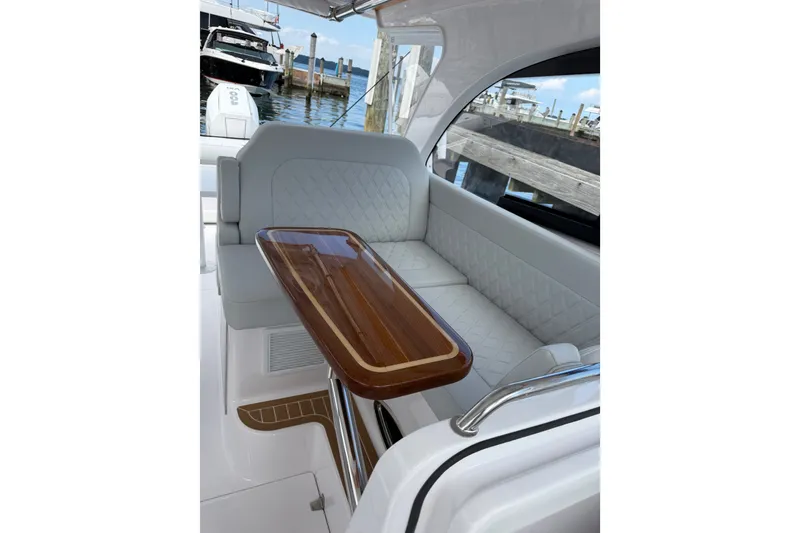 Slide: The Image of Luxurious seating area on 2024 Southport 33 DC boat with elegant wooden table. - 12