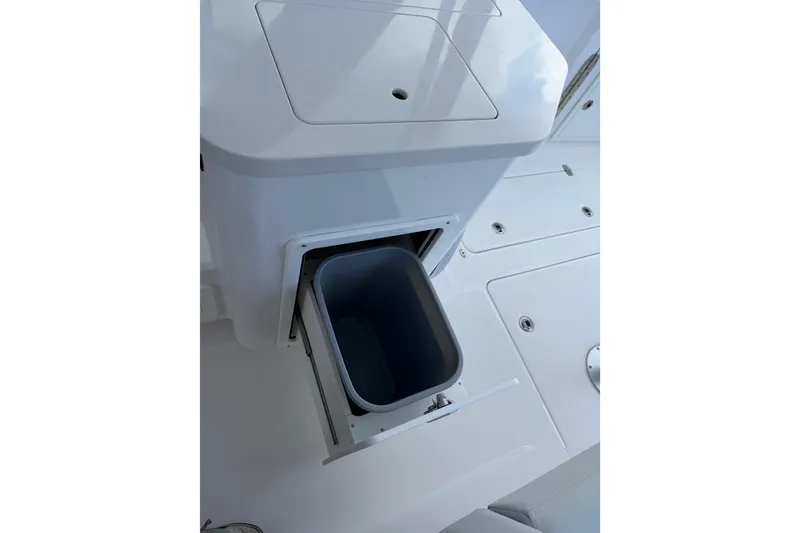 Slide: The Image of 2024 Southport 33 DC boat interior with built-in storage compartment. - 15
