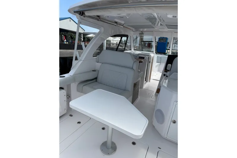 Slide: The Image of 2024 Southport 33 DC boat interior with seating and table, showcasing modern design. - 14