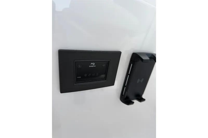 Slide: The Image of 2024 Southport 33 DC boat control panel with Dometic interface. - 21