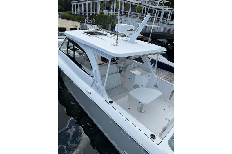 Slide: The Image of 2024 Southport 33 DC boat docked, featuring sleek design and modern amenities. - 0