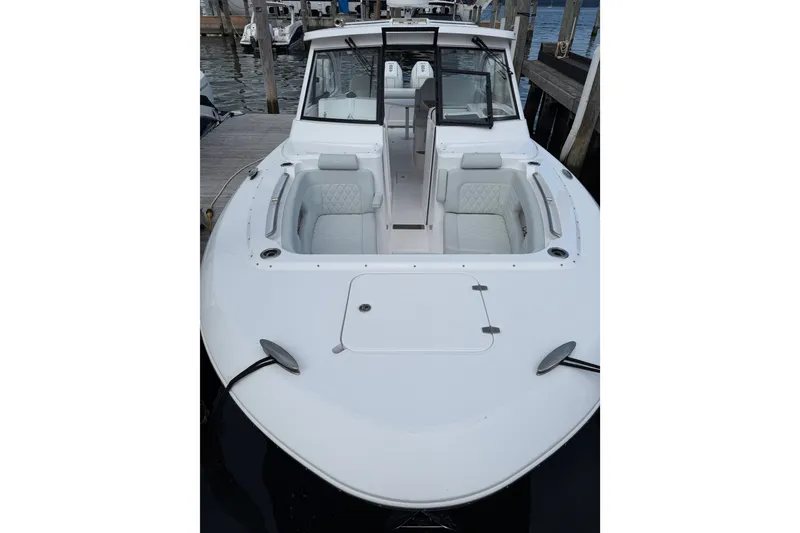 The Image of 2024 Southport 33 DC boat docked, featuring spacious seating and sleek design. - 4