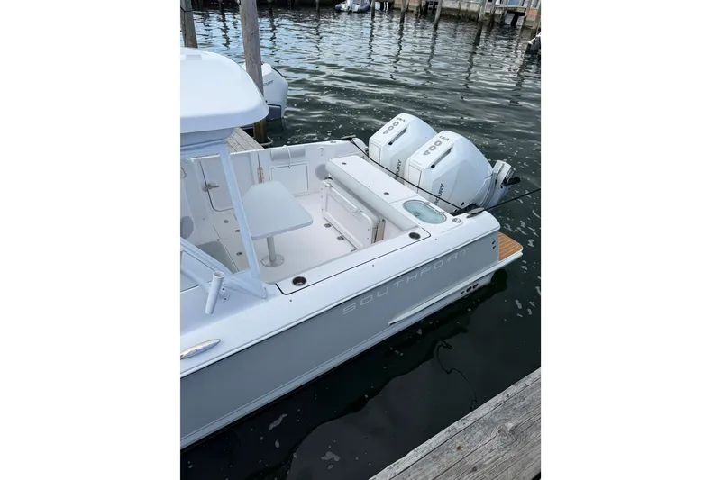 Slide: The Image of 2024 Southport 33 DC boat docked with dual outboard engines. - 7