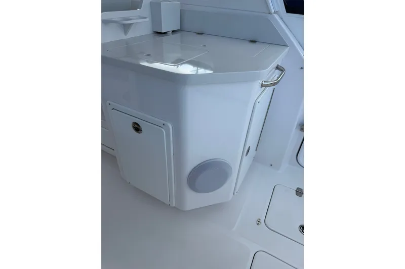 Slide: The Image of 2024 Southport 33 DC boat interior detail with storage compartment and speaker. - 33