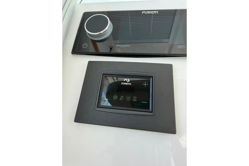 Slide: The Image of Control panel and display in 2024 Southport 33 DC boat interior. - 20