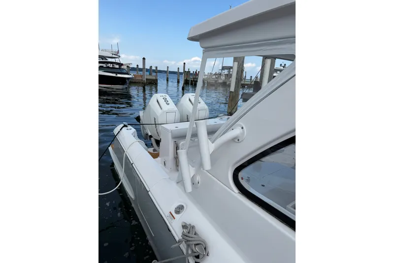 Slide: The Image of 2024 Southport 33 DC boat docked with twin engines, featuring sleek white design. - 3
