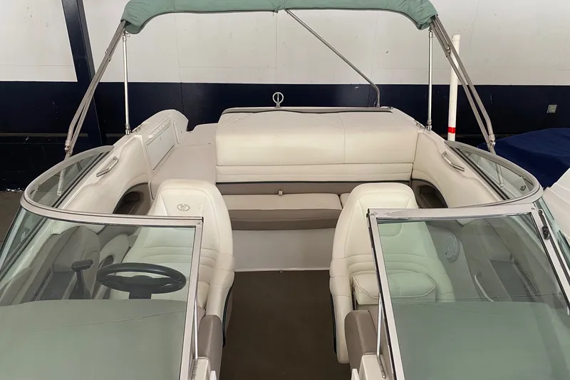 Slide: The Image of 2002 Cobalt 206 boat interior with white seating and green canopy. - 9