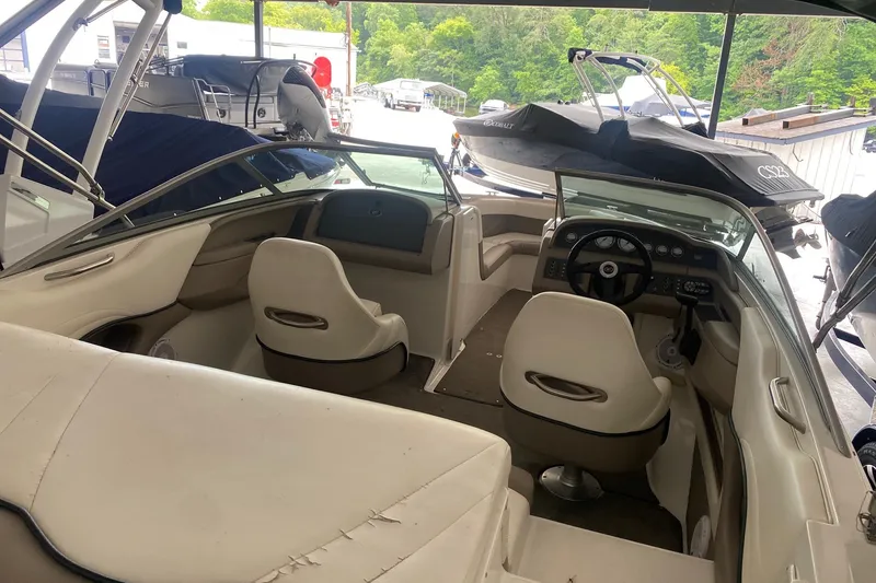 Slide: The Image of Interior of a 2002 Cobalt 206 boat with white seating and dashboard. - 2