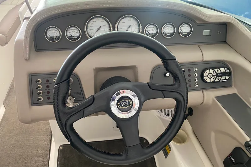 Slide: The Image of Steering wheel and dashboard of a 2002 Cobalt 206 boat, featuring gauges and controls. - 6