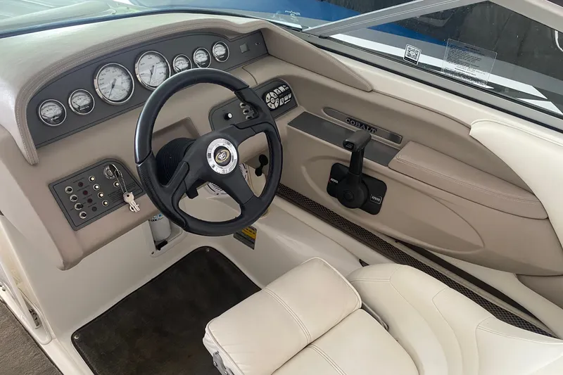 Slide: The Image of Interior of a 2002 Cobalt 206 boat featuring steering wheel and dashboard controls. - 4