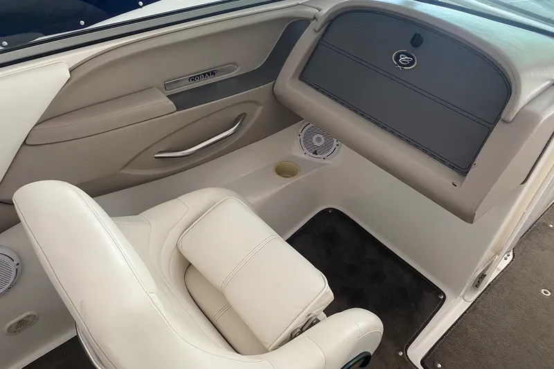 Slide: The Image of Interior of a 2002 Cobalt 206 boat with white seating and dashboard. - 7