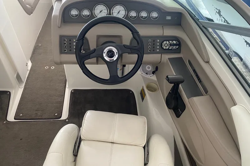 Slide: The Image of Interior of a 2002 Cobalt 206 boat with steering wheel and dashboard controls. - 5