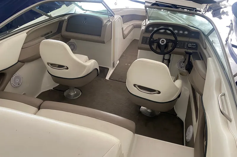 Slide: The Image of Interior of a 2002 Cobalt 206 boat with white seating and modern dashboard. - 3