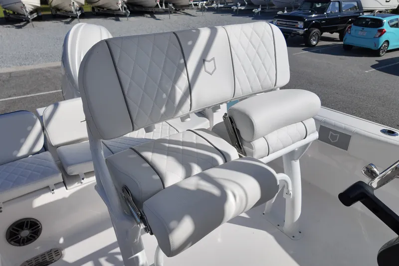 Slide: The Image of 2027 Sea Fox 228 Commander boat interior with white cushioned seating and steering wheel. - 7