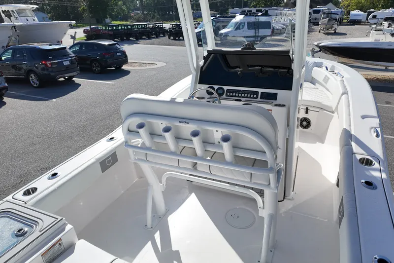 Slide: The Image of 2027 Sea Fox 228 Commander boat interior with helm and seating, parked in a lot. - 16