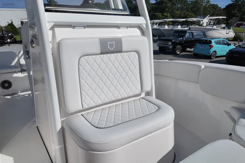 Slide: The Image of 2027 Sea Fox 228 Commander boat interior with white cushioned seating and diamond stitching. - 11