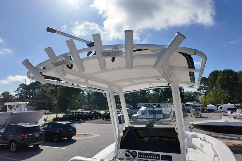 Slide: The Image of 2027 Sea Fox 228 Commander boat with T-top and rod holders in a marina setting. - 15