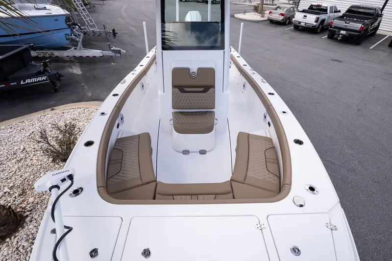 Slide: The Image of 2026 Blackfin 262 HB boat with spacious seating and modern design in a marina setting. - 14