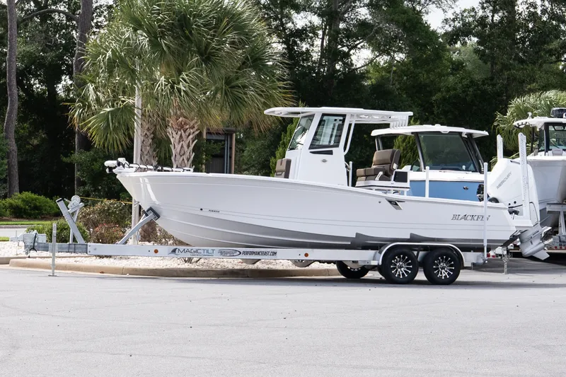 The Image of 2026 Blackfin 262 HB boat on trailer, parked near palm trees. - 1