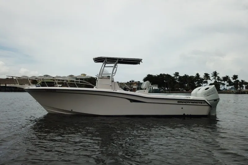 Slide: The Image of 2003 Grady-White Advance 257 boat on calm water, side view. - 13