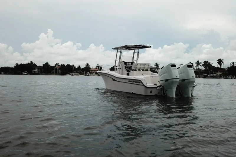 Slide: The Image of 2003 Grady-White Advance 257 boat on calm water, cloudy sky backdrop. - 16